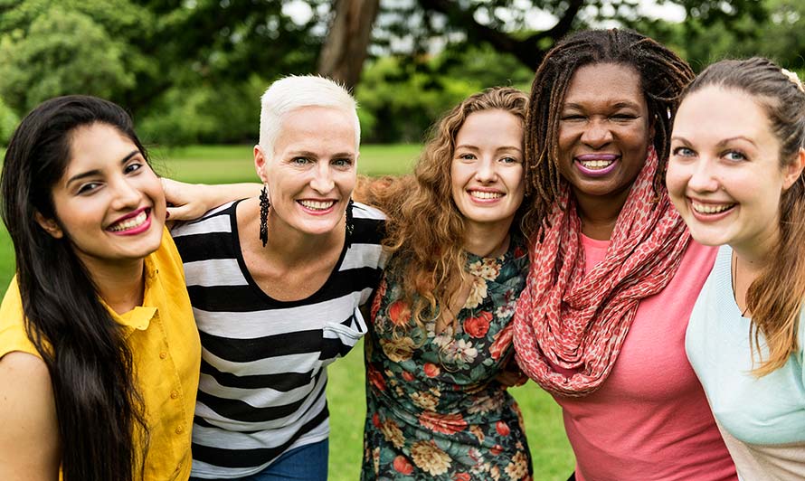 Group of women holding each other and smiling